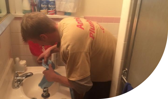 An expert from Antrim Plumbing installing a brand new faucet for a powder room, Faucet Repair and Installation Services in The Delaware County, PA