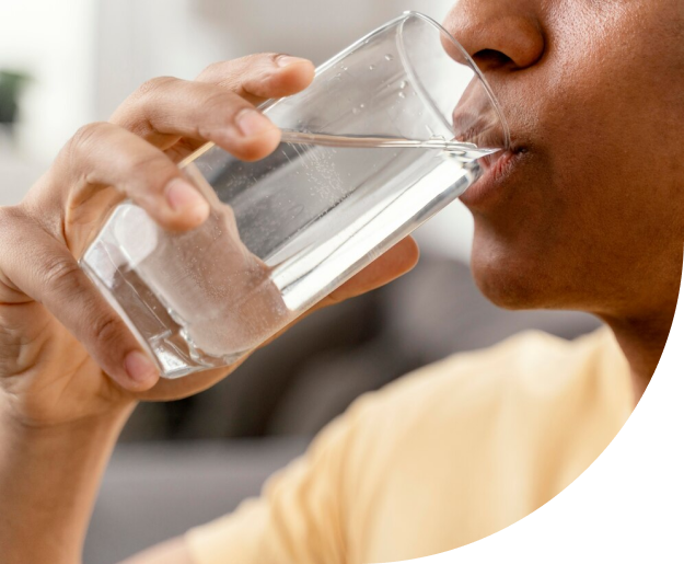 A man enjoying his clean water through the Reverse Osmosis Installation by Antrim Plumbing, Reverse Osmosis Installation in Delaware County, PA