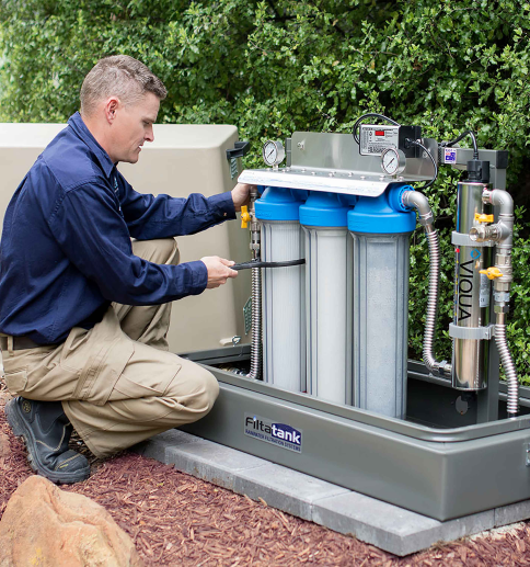 A man installing a water filtration sytem, Water Filtration System Services in The Delaware County Area