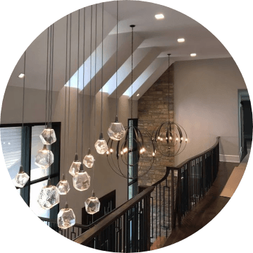 Chandeliers hanging from the ceiling in a home, installed by a skilled team of Antrim Plumbing.