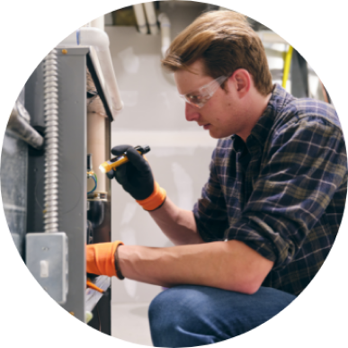 A man checking a home heating system for repairs, Home Heater Repair in Delaware County, PA