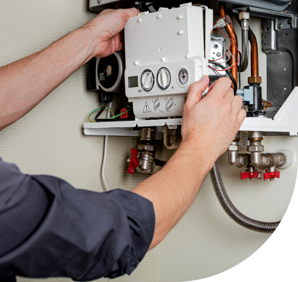 A man servicing a water heater system