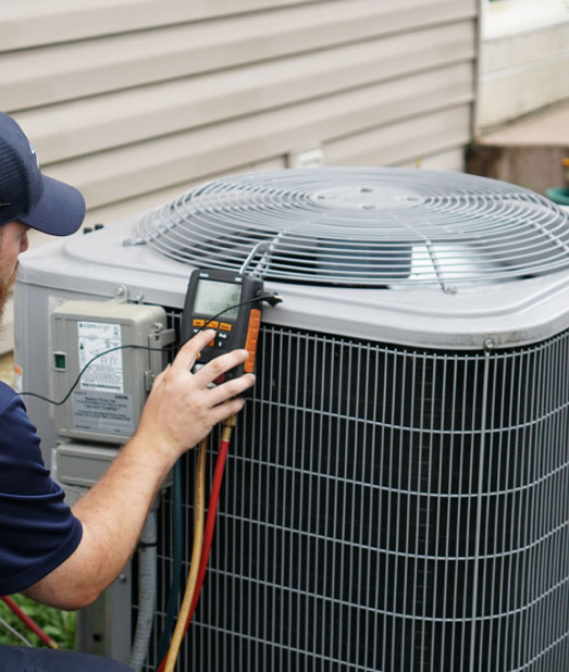 A man checking the functionality of installed heat pump system, Heat Pump Services in Delaware County, PA