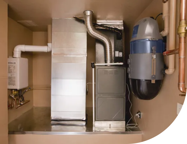 A compact room housing a furnace and water heater, providing essential heating and hot water services, Gas and Electric Furnace in Delaware County, PA